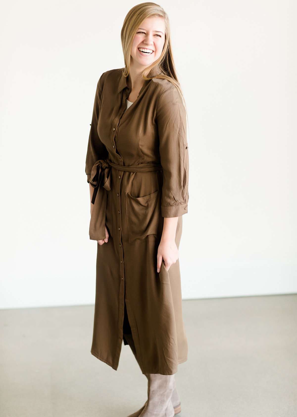 Olive colored belted midi dress with buttons running down the front.