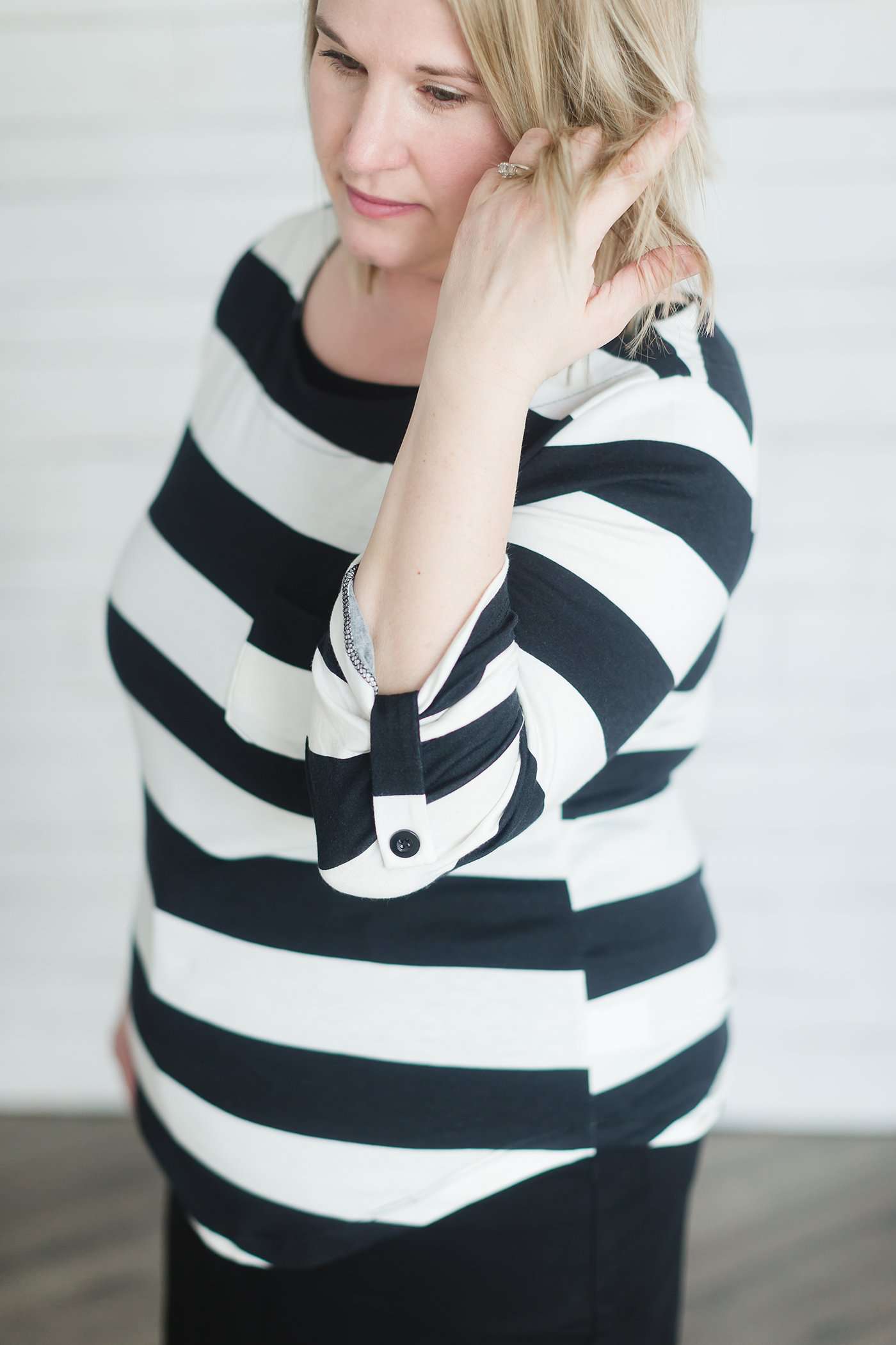 Modest black and white stripe, three quarter length sleeve with front pocket.