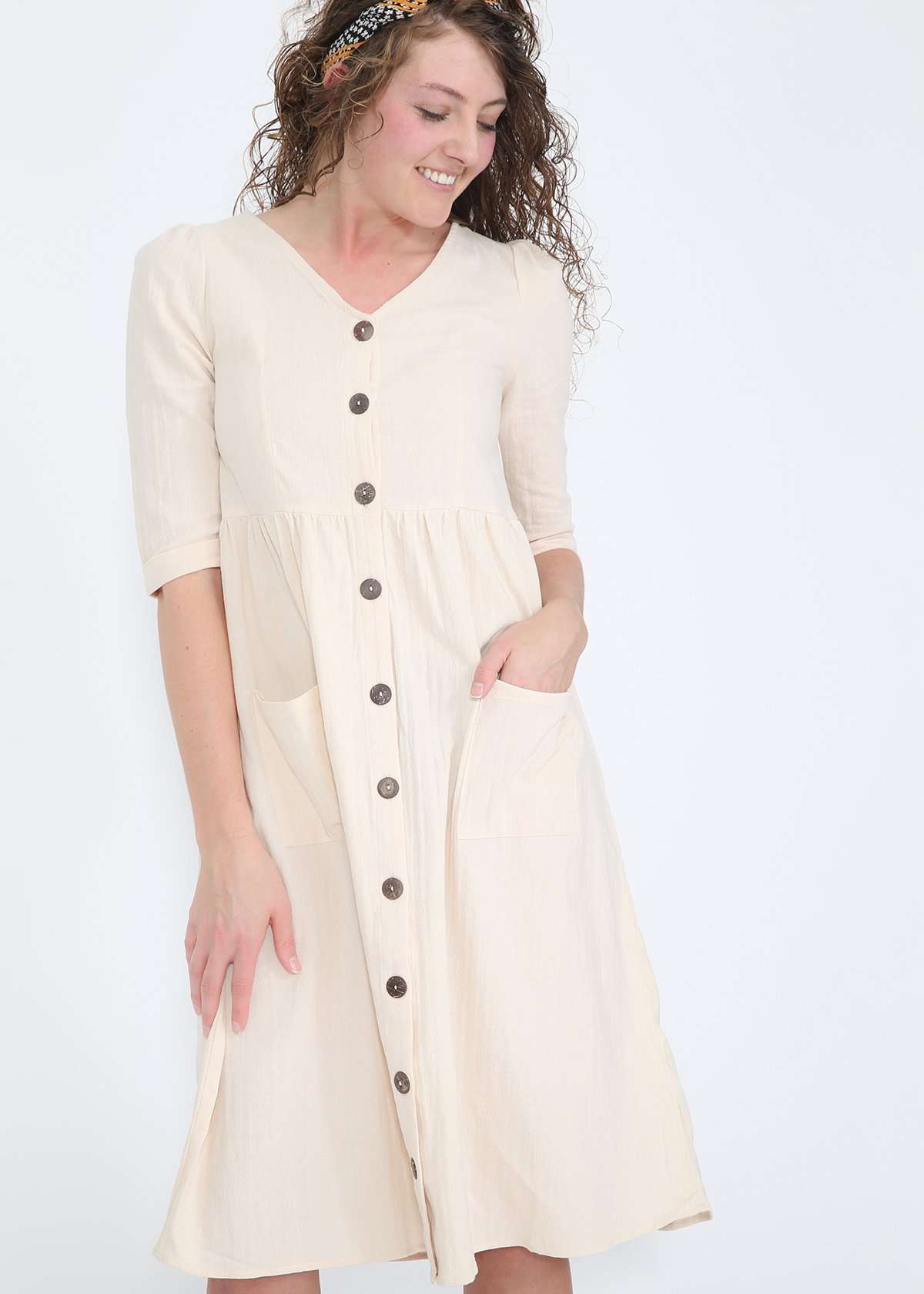 Modest women's cream cotton dress with brown buttons and half sleeves