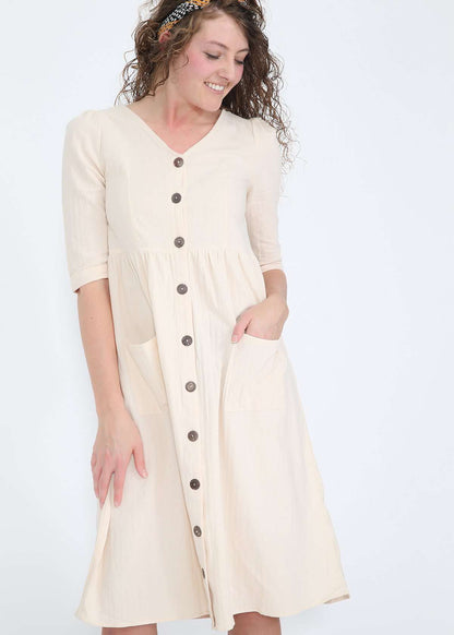 Modest women's cream cotton dress with brown buttons and half sleeves