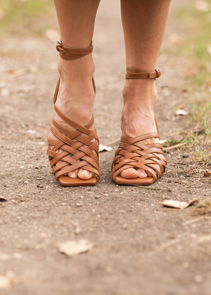 Charter Leather Shoe Shoes have a crisscross cage-like brown leather upper, leather insole, rubber sole, silver side-buckle closure, and thin block heel.  Edit alt text