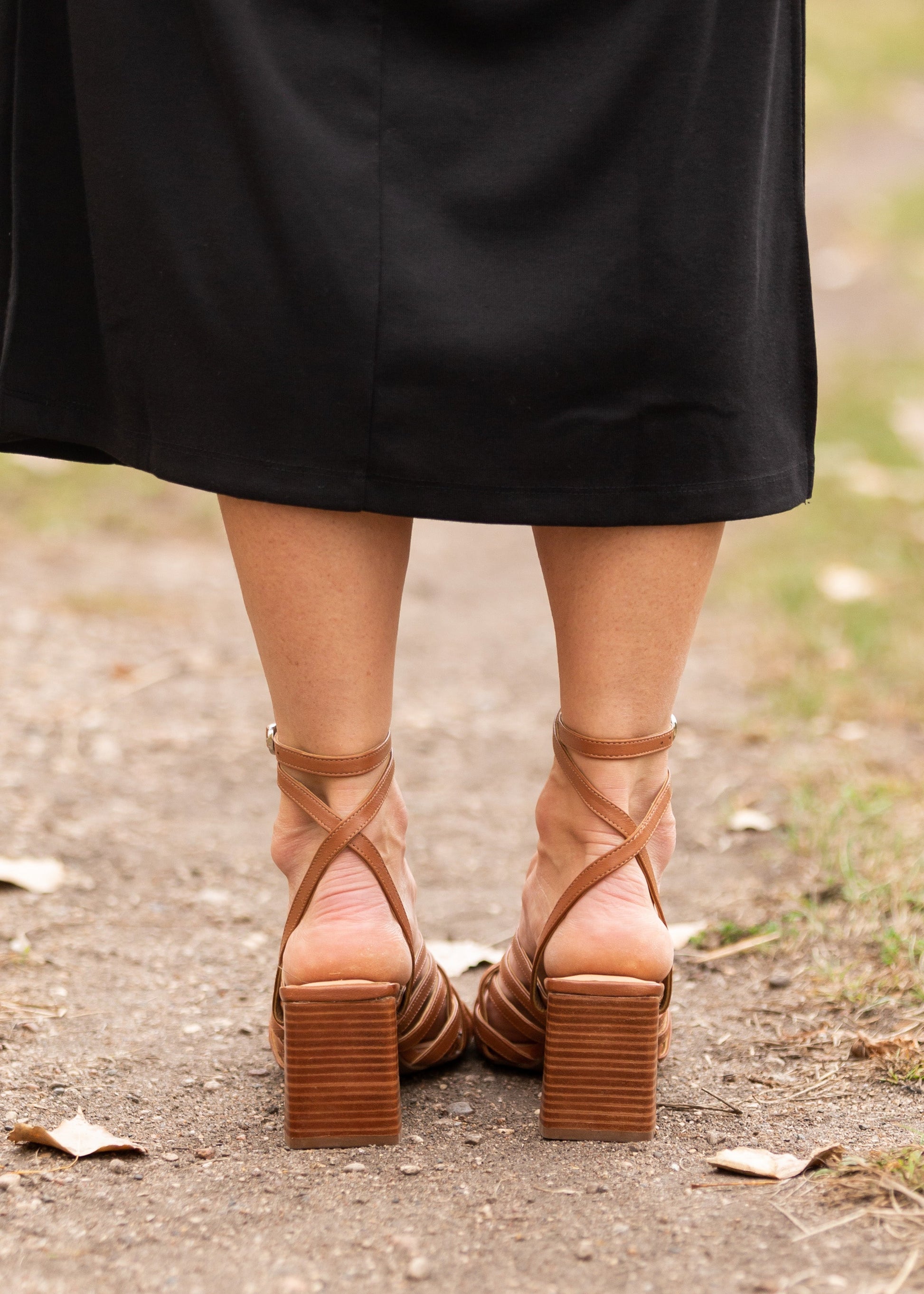 Charter Leather Shoe Shoes have a crisscross cage-like brown leather upper, leather insole, rubber sole, silver side-buckle closure, and thin block heel.  Edit alt text