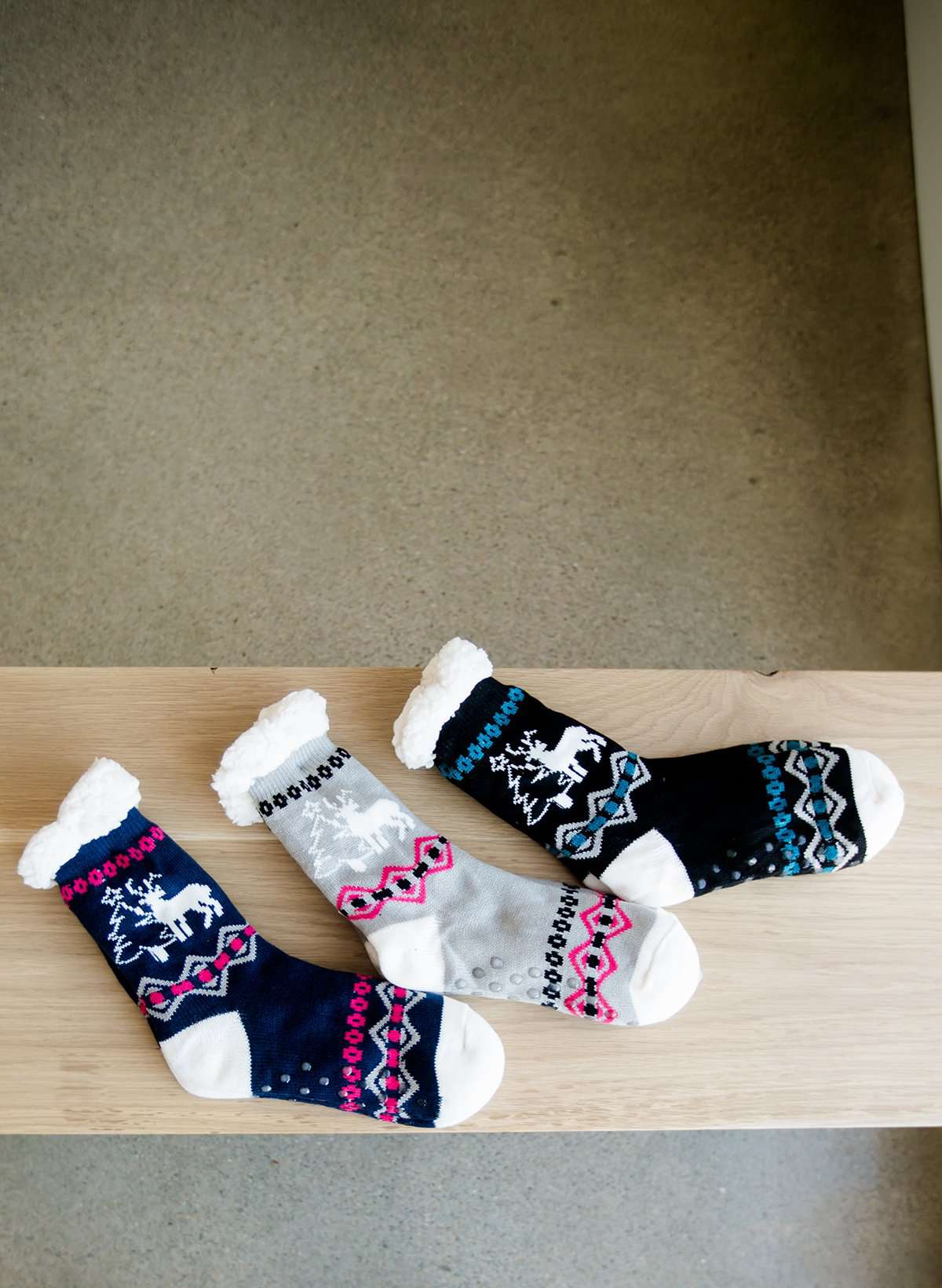 Reindeer and Pine Tree Christmas scene slipper socks in gray, navy and black.