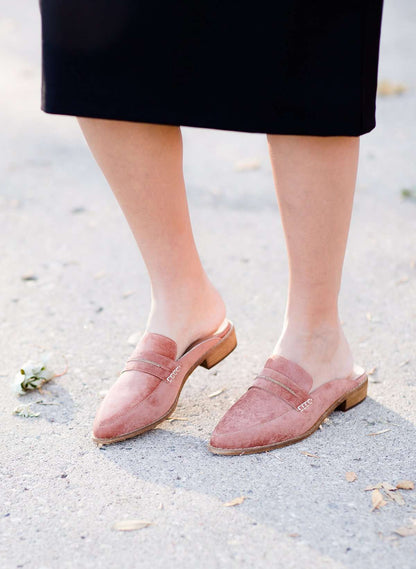 Woman wearing a classic copper colored backless genuine leather loafer