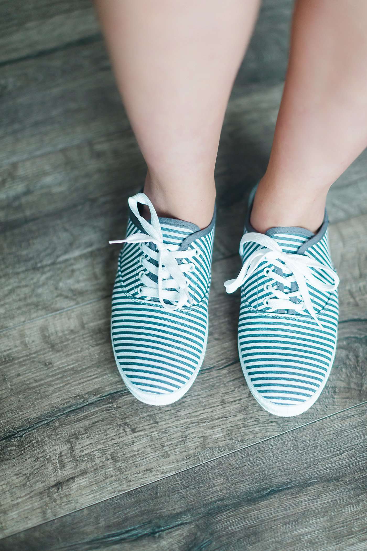 grey and white striped sneaker with white sole and laces.