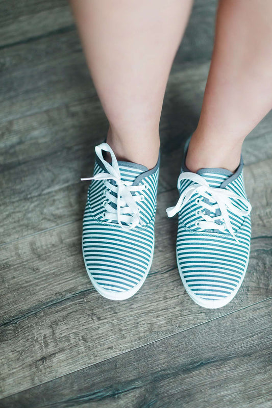 grey and white striped sneaker with white sole and laces.