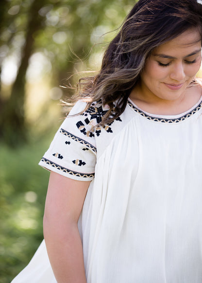 oatmeal colored flowy embroidered midi dress