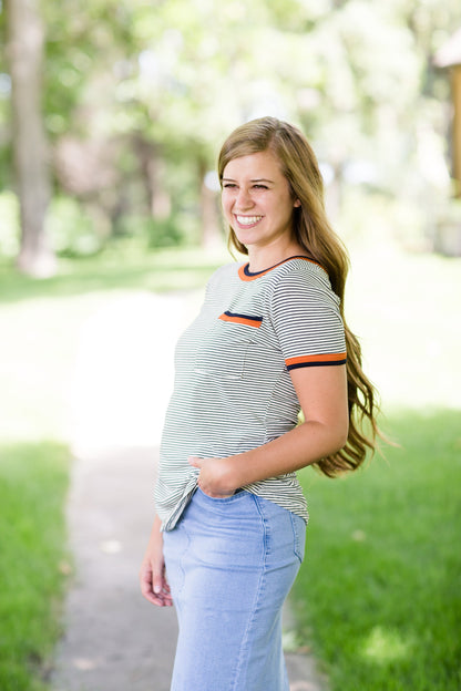 Navy striped tee with a rust accent and front pocket