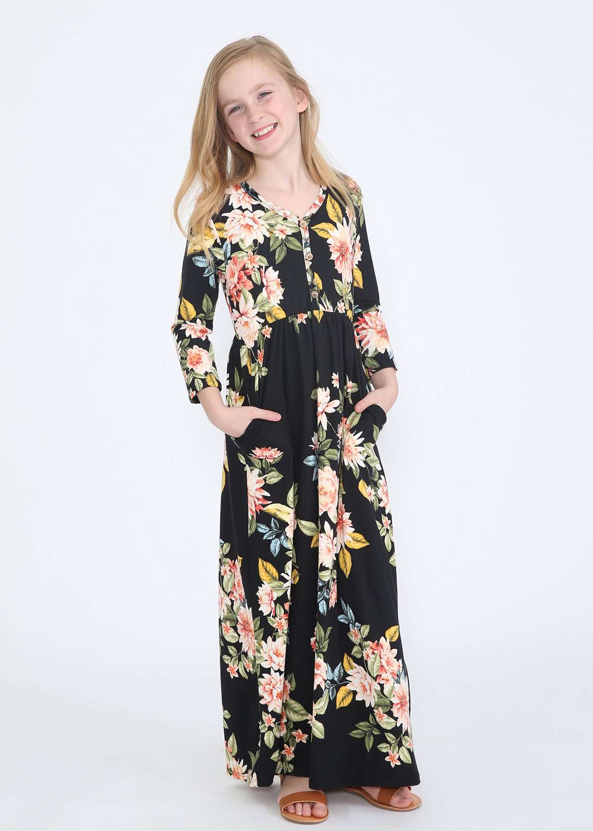 young girl wearing a modest black maxi dress with flowers on it