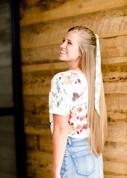 Modest cream tee with multi-colored floral detail 