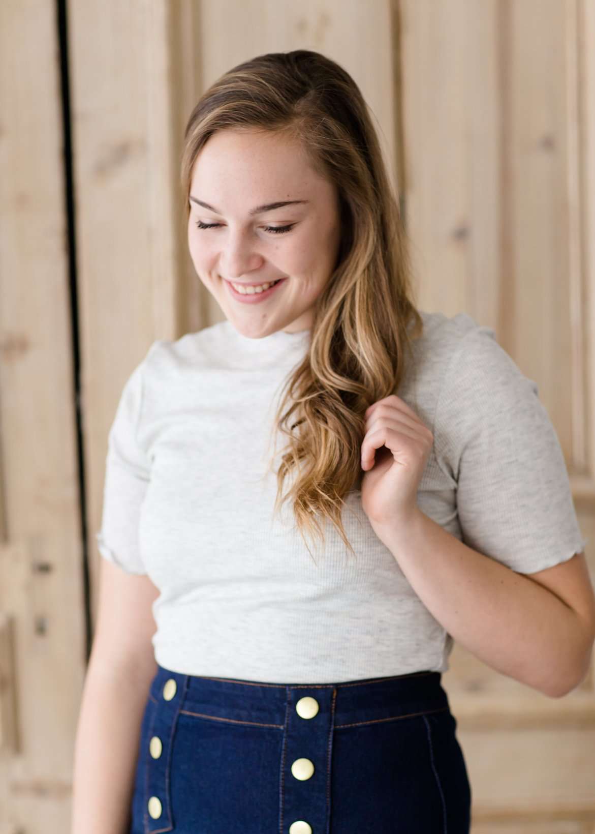 woman wearing a gray mock neck short sleeve top