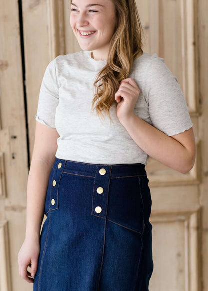 woman wearing a gray mock neck short sleeve top