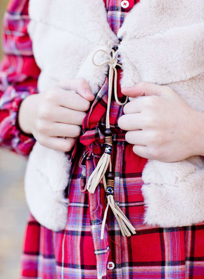 Young girl wearing a modest red plaid midi dress with balloon style sleeves. This dress also features a self tie fabric waist and is lined.