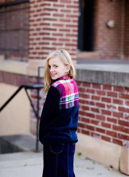 This half zip pullover features a front pouch pocket and a beautiful color block print of fuchsia, teal and mustard!  This young girl is also matching her mother in a mommy and me style.