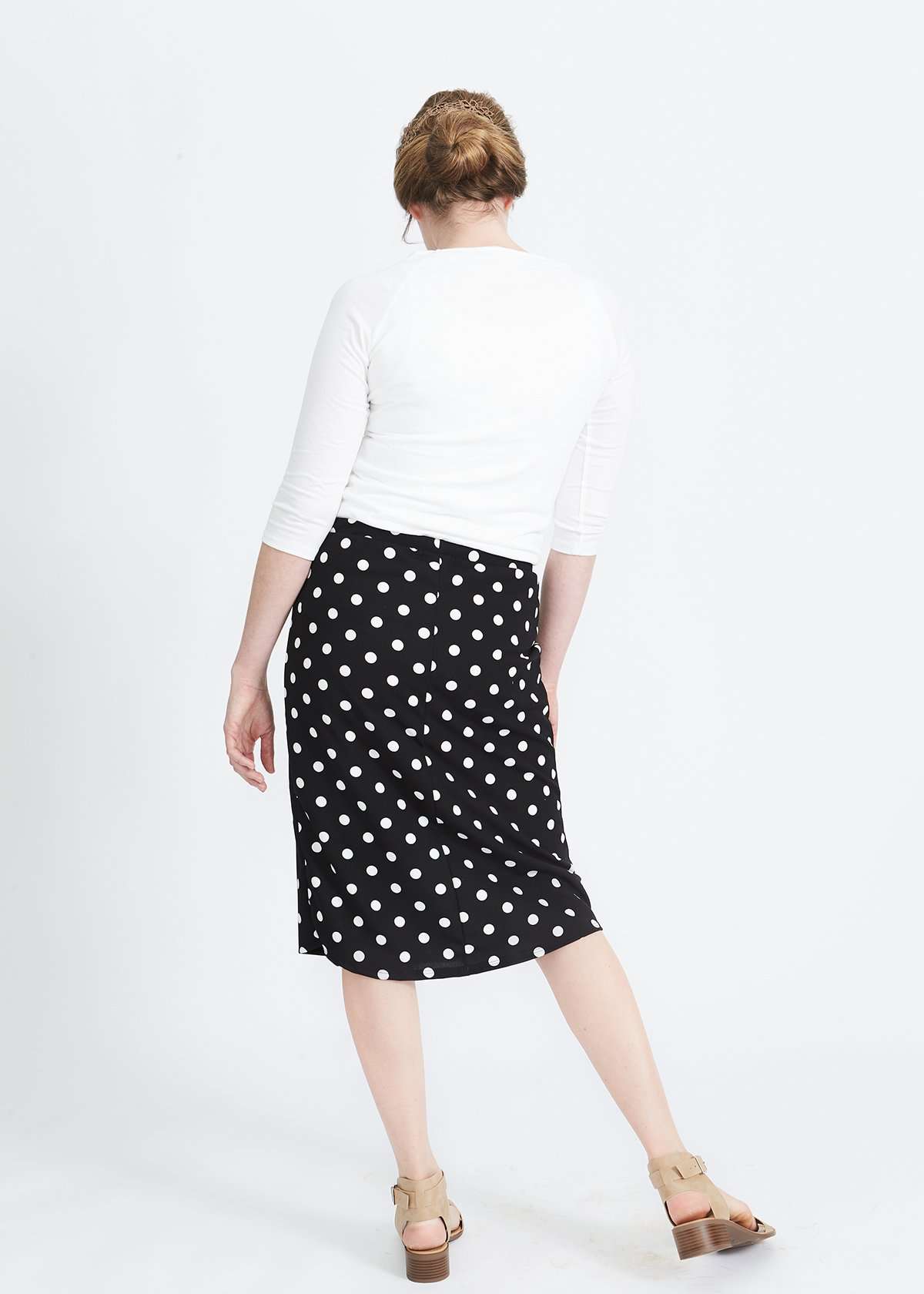 Woman wearing black and white stretch polka dot dress skirt